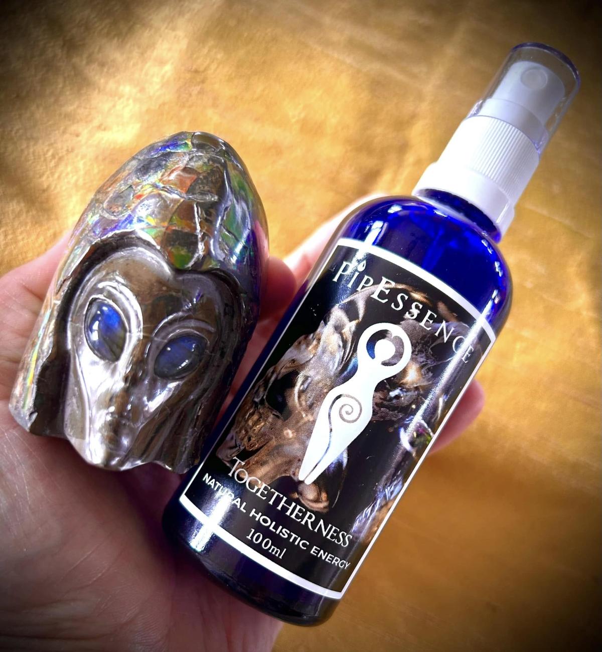 The Togetherness essence held beside an opal crystal skull